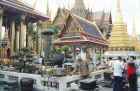 Incense burning area, an emerald Buddha resides in the temple on the left.